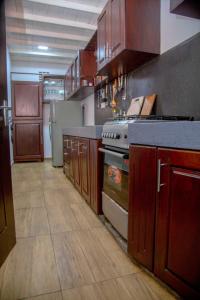 a kitchen with wooden cabinets and a stove in it at Wagon Wheel Inn in Busse