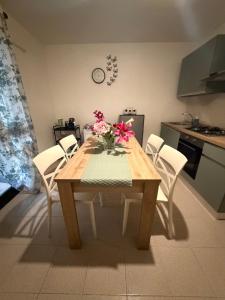 a dining room table with a vase of flowers on it at CASA ELISA in Cavo +6 photos