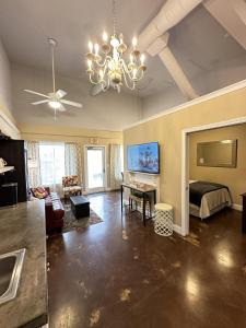 a large living room with a bed and a chandelier at Haven at Hazel~Downtown Bungalow in Demorest