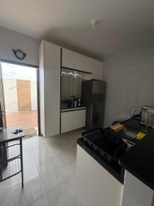 a kitchen with a black couch in a room at Casa de praia PB in Pitimbu