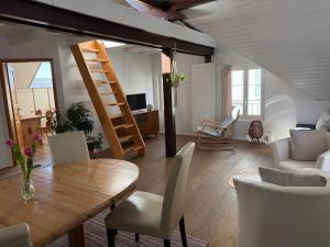 a living room with a wooden table and chairs at Apartment in Düdingen in Düdingen