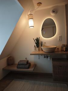 a bathroom with a sink and a mirror at Slow Suite & Spa Erstein in Erstein +5 photos