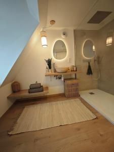 a bathroom with a sink and a rug on the floor at Slow Suite & Spa Erstein in Erstein