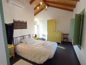 a bedroom with a bed and a tv in a room at La Casa Vecchia in Nuraminis