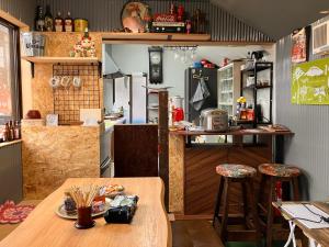a kitchen with a wooden table and a counter at はやちねの宿ラビット in Hanamaki