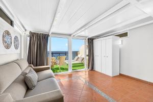 a living room with a couch and a view of the ocean at Villa Brisa Serena - Oceanfront - Los Cristianos in Los Cristianos