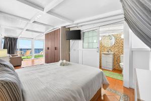 a bedroom with a white bed and a television at Villa Brisa Serena - Oceanfront - Los Cristianos in Los Cristianos +42 photos