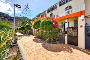a street in front of a building with plants at Villa Brisa Serena - Oceanfront - Los Cristianos in Los Cristianos