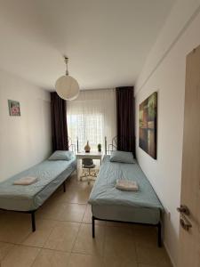 a bedroom with two beds and a desk in it at 2 Bedrooms At Caesar Resort & Spa Iskele Claudius 9 in Iskele