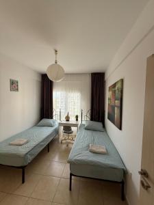 a bedroom with two beds and a table with a desk at 2 Bedrooms At Caesar Resort & Spa Iskele Claudius 9 in Iskele
