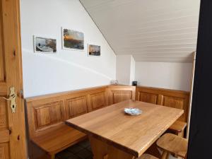 a dining room with a wooden table and chairs at Apartment in Düdingen in Düdingen +6 photos