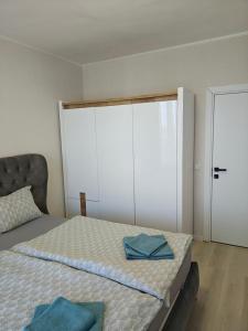 a bedroom with a bed with blue towels on it at Ines - Golf und Meer Bulgarien in Balchik +23 photos
