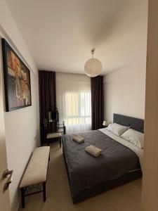 a bedroom with a large bed and a chair at 2 Bedrooms At Caesar Resort & Spa Iskele Claudius 9 in Iskele