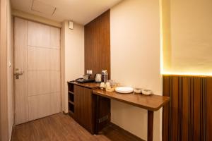 a room with a kitchen with a table and a door at The Sterling Omaxe Near Expo Mart in Greater Noida