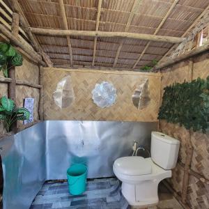 a bathroom with a toilet and a tub at Island Crib in El Nido +31 photos