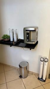 a kitchen counter with a toaster oven and a toaster at Hotel Olympia in Cláudio +23 photos