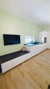 a living room with a couch and a large tv at Casa Paradiso La Cinta San Teodoro in San Teodoro