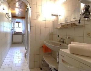 a white bathroom with a sink and a mirror at Gschwandnerhof in Michelsneukirchen +31 photos