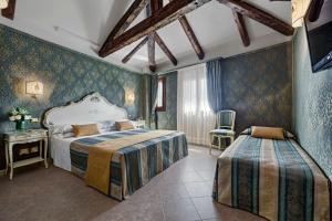 a bedroom with two beds in a room at Antica Locanda al Gambero in Venice