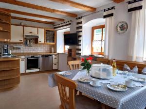 a kitchen and dining room with a table and chairs at Gschwandnerhof in Michelsneukirchen