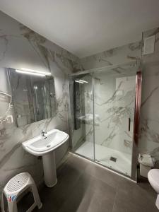 a bathroom with a sink and a shower at Hotel Carlos III in Águilas