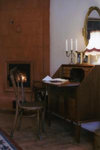 a desk with a chair in a room with a fireplace at Anija mõis in Anija