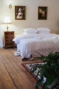 a bedroom with a bed and a table with a lamp at Anija mõis in Anija