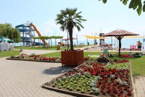 a park with flowers and a roller coaster at Mirabella apartman in Csopak