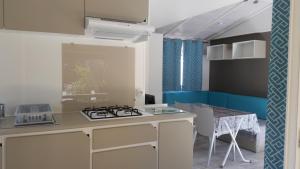 a kitchen with a stove and a table in it at Camping A Torra in Galeria
