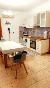 a kitchen with a table and chairs in it at Mar&Mat in Giarre