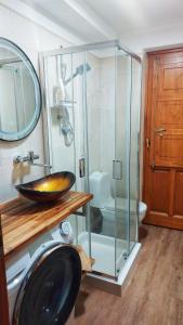 a bathroom with a glass shower and a sink at Mar&Mat in Giarre