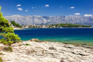 a view of a body of water with mountains at Studio Ruzmarin in Selca