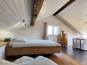 a bedroom with a large bed in a attic at Cœurvert Nature Silence, Panorama - Ronchamp & Le Corbusier in Ronchamp