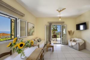 a living room with a couch and a table at Kefalonian Oneira Villas in Mousata