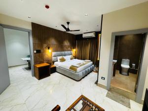 a hotel room with a bed and a bathroom at Mannat Hotel in Tezpur +9 photos