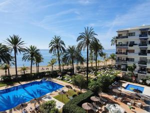 an aerial view of a resort with a pool and palm trees at Skol 617 Beachfront Two-bedrooms Duplex With Sea Views in Marbella