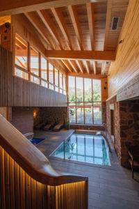 an indoor pool in a house with a large window at Camping Prades Park in Prades