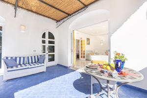 a living room with a table and a couch at YourHome - Villa Allegria in Positano