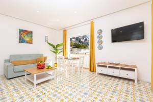 a living room with a couch and a table at YourHome - Villa Allegria in Positano