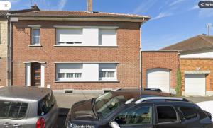 two cars parked in front of a brick building at L'Escapade Secrète balnéo - sauna - love room in Arras