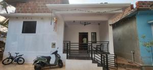a scooter parked in front of a house at Daji Dhabolkar house in Mandrem