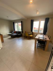 a living room with a couch and a table at Maison luxueuse proche de Paris centre in Aulnay-sous-Bois