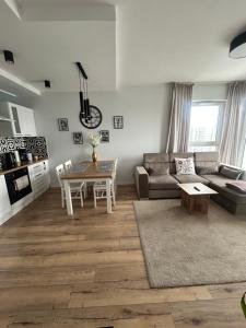 a living room with a couch and a table at SeaView Apartament in Gdańsk Letnica