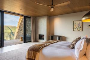 a bedroom with a large bed and a fireplace at Mantis Hiddn in Addo in Addo +65 photos