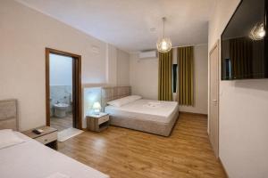 a hotel room with a bed and a bathroom at Hotel Globo in Durrës +56 photos