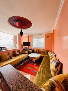 a living room with a couch and a table at Vitamin taliouine appartement in Taghazout