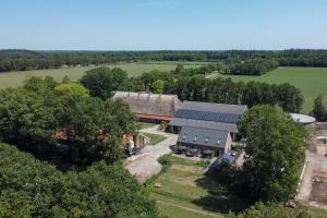 an aerial view of a farm with a building with solar panels at Hoeve Koning Willem III in Frederiksoord