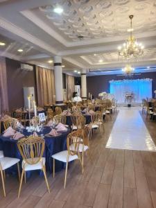 a banquet hall with tables and chairs and a chandelier at Bella Casa Hotel in Monrovia +42 photos