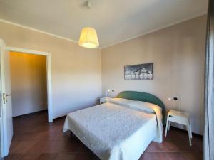 a bedroom with a bed and a pendant light at Villa la Tranquilla in Baveno