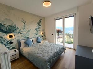a bedroom with a bed with a floral wall at Cà di Cambret with lake View in Stresa